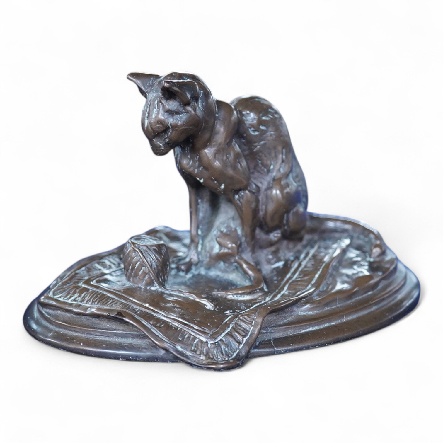 After Emmanuel Fremiet (1824-1910), a study of a seated cat, signed, 13cm wide